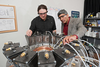 UD doctoral student Erik Koepf (left) and Ajay Prasad, professor of mechanical engineering, inspect the novel solar reactor.