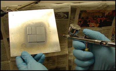 Figure 3: CIGS nanocrysal "ink" being airbrushed onto soda-lime glass substrates with a metal back contact.